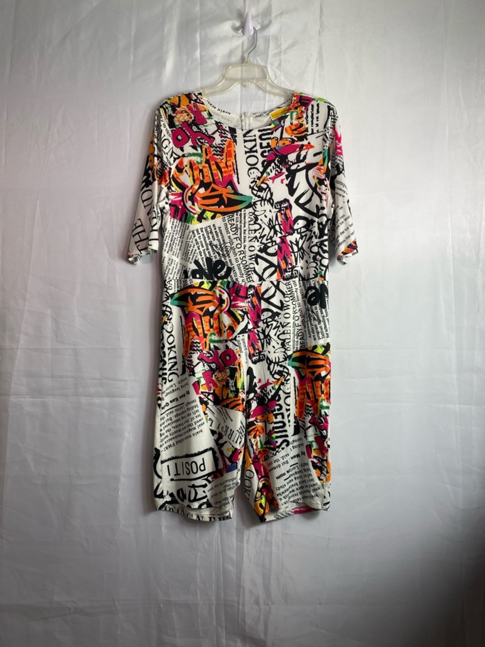 Graphic Newspaper Print Short-Sleeve Jumpsuit in White with Neon Accents